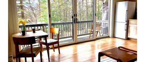An expanse of sliding glass doors leads to the balcony, with mountain views.
