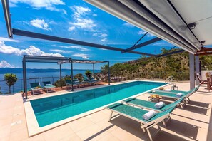 heated 11m x 3,6m private pool, huge sun deck area with 9 modern deck chairs