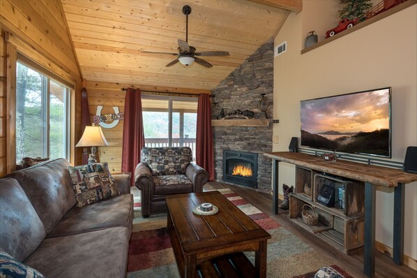 At Rainbows Edge living room area with smart tv and gas logs fireplace