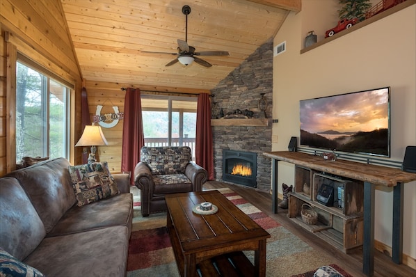 At Rainbows Edge living room area with smart tv and gas logs fireplace
