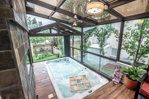 Relax in the enclosed sunroom with the spacious swim spa. the only shared space.