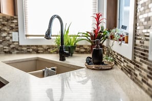 Kitchen sink offers a bright and inviting space to prepare meals. 