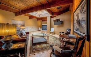 Comfortable living room with smart tv and original, local artwork featured prominentaly