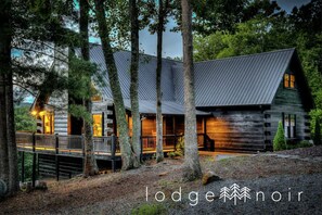 A true log cabin, with a modern twist. Check out the wrap around porch/deck!