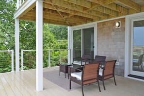 Relax on the deck overlooking Sandy Bay and Pigeon Cove.