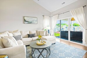 Living Room with sectional, TV & sliders to the deck.