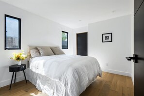 Serene and stylish! This white queen-size bedroom is your perfect retreat for relaxation.