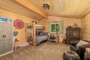 Main floor bedroom with twin over full bunkbed and desk