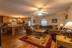 Huge sectional couch adjacent to kitchen area allowing for guests to spread out.