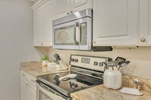 The kitchen comes fully equipped with high end appliances and sleek granite benchtops