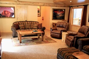 Living Room with rock fireplace and Queen HB