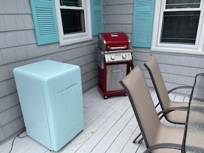 Side porch with gas grill, small fridge and dining for 6