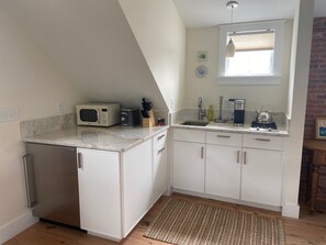 Nicely equipped kitchenette with cooktop and subzero fridge