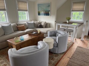 Living room area with private entryway staircase 