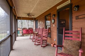 Screened front porch with rockers and a swing