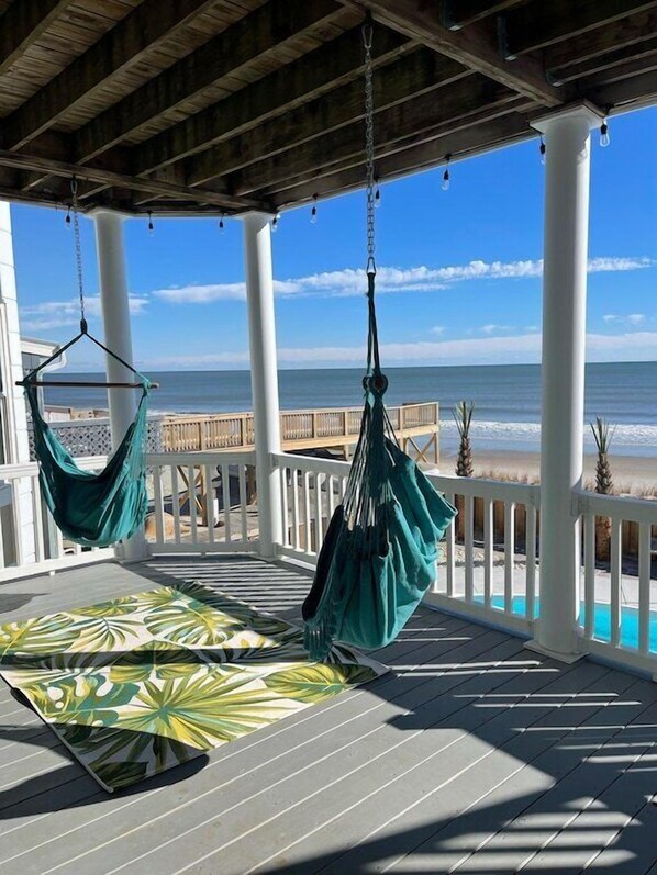 Hammock chairs on 2nd floor deck above the pool