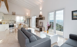 Living, Dining and Kitchen area with balcony that overlooks pool deck with views