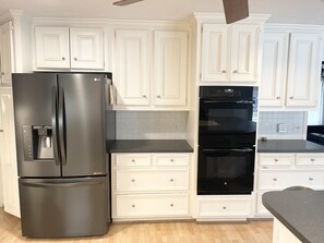 Two ovens and a smart oven. Refrigerator with easy access to ice and water. 