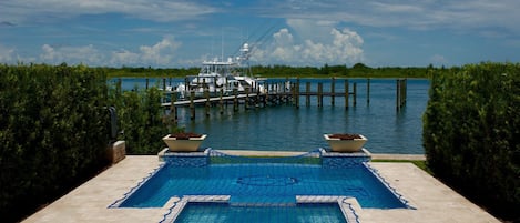 Pool Deck with spa, fire bowls and view of the Fort Pierce Inlet
