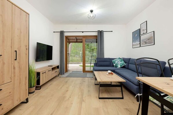 Cozy living room with sofa bed, TV and access to the terrace/patio.