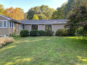 Rear view of home with sliders to a back patio