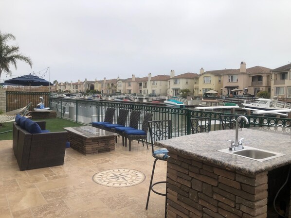 Rear patio fire pit and bar area overlooking the marina.