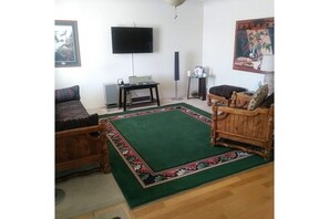 Comfortable Living Room with Sofa, Chair, Stereo, and TV