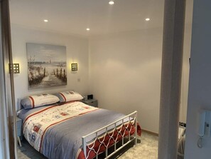 Main bedroom with king size bed and feature lighting 