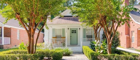 Front of House- Adorable and White and Green House with Beautiful Landscaping