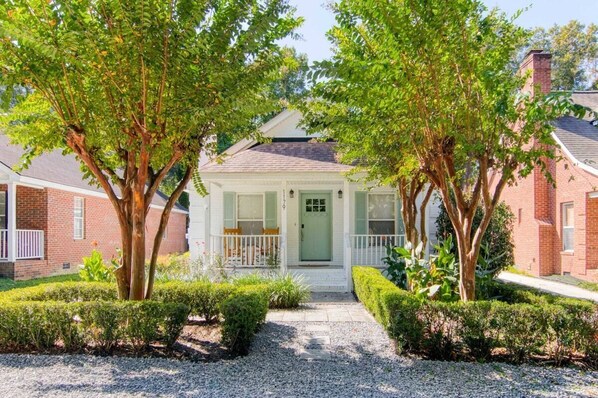 Front of House- Adorable and White and Green House with Beautiful Landscaping