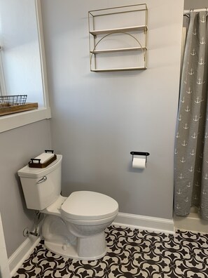 Full bath, features shower and basic toiletries.