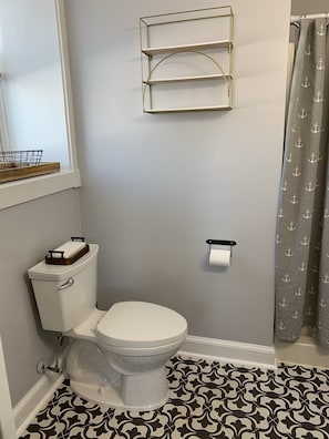 Full bath, features shower and basic toiletries.