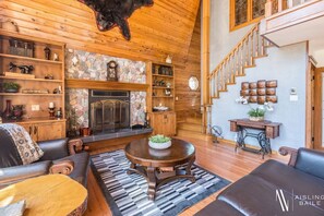 Private living room with a wood-burning fireplace & 20 foot floor-to-ceilings windows.