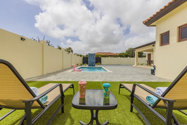 Lounge Chairs Facing The Pool Area