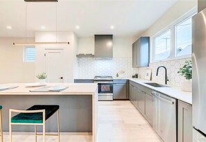 Bright and Modern Kitchen with Counter Space and Stainless-Steel Appliances