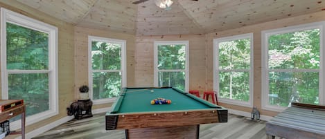 4.5' x 8' Pool table and dart board in games room.