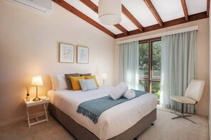 A cosy second bedroom includes a queen-size bed and an AC.