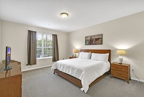 Master bedroom w/ king bed and en-suite bathroom