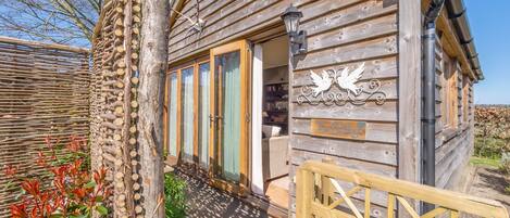 The Bothy garden is fully enclosed with hurdle fencing