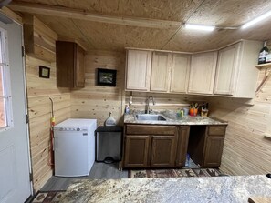 The sink area with propane refrigerator 