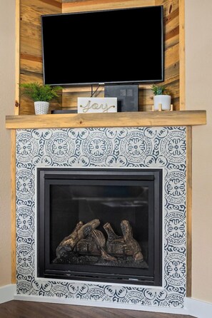 The gorgeous, new fireplace will keep your toes cold on a cold winter's day.