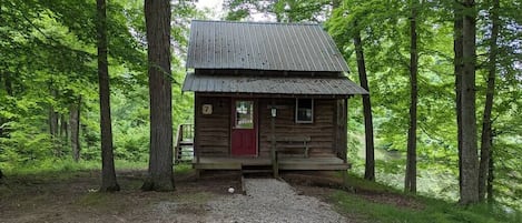 Outside view of Cabin 7 with lake in the back.