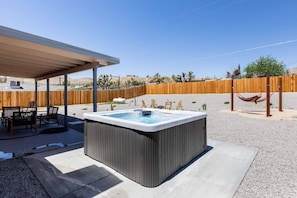 View of back yard space and hot tub.