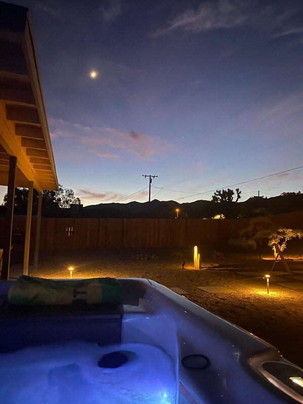 Lovely photo of the back yard at sundown. View from hot tub.