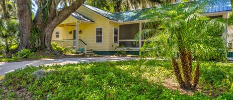 The house features an open screened-in porch between the main house and studio.