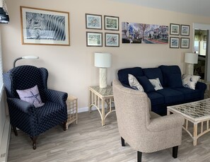 Wingback chair with lamp for reading.