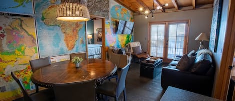 Beautiful dining area opens into cozy living space with amazing map wall.