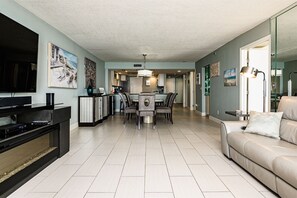 A look from the spacious living room into the dining area and kitchen