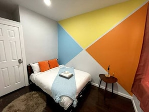 Welcome to our colorful bedroom, a whimsical sanctuary of vibrant hues and playful design. From the moment you enter, you'll be greeted by a kaleidoscope of colors, brightening your mood and sparking joy. Soft pastel walls complement bold patterned bedding, creating a harmonious balance of fun and tranquility. Each carefully chosen decor piece adds a pop of personality, making ...