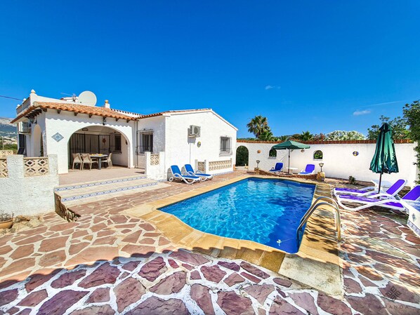 Pool terrace area with sun loungers and parasols